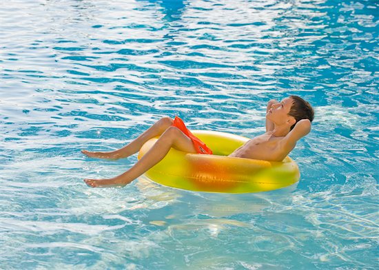 Boy relaxing in inflatable tube