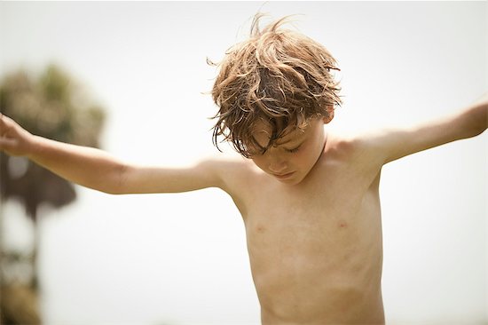 Bare-chested boy playing outdoor