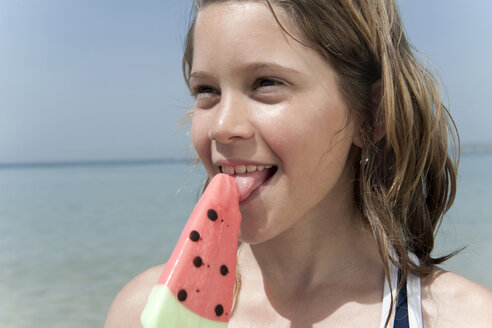 spain-mallorca-girl-10-11-holding-ice-cream-on-beach-portrait-WE