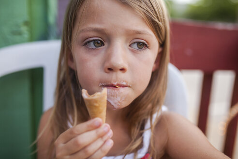 girl-looking-away-while-eating-ice-cream-CAVF38359.jpg